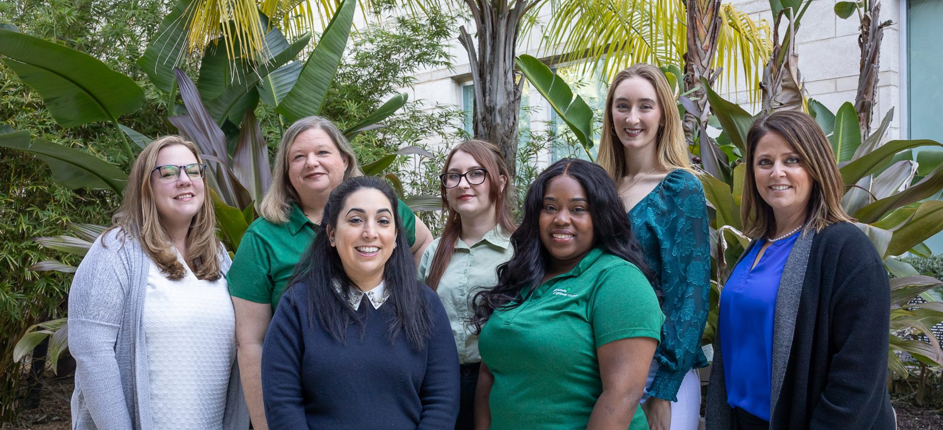  girl scout staff or volunteer wearing adult vest in woods smiling 